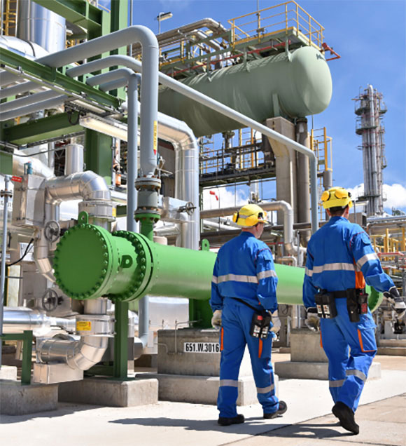Group of workmen in a petroleum refinery managing industrial wastewater