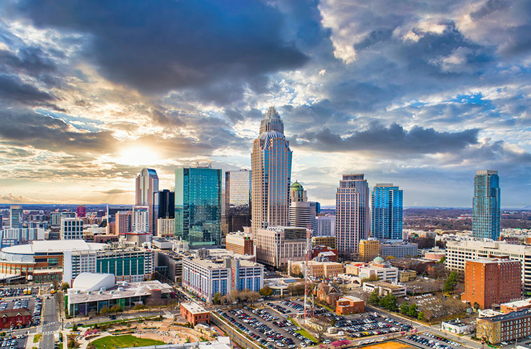The city of Charlotte, North Carolina with clouds in the sky. 