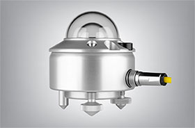 The Kipp & Zonen CMP10 pyranometer, a small silver with a double glass dome on top and yellow cable extending from the side.
