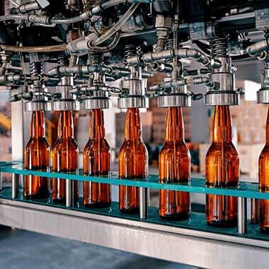 Beer bottles in an automated filling line. 