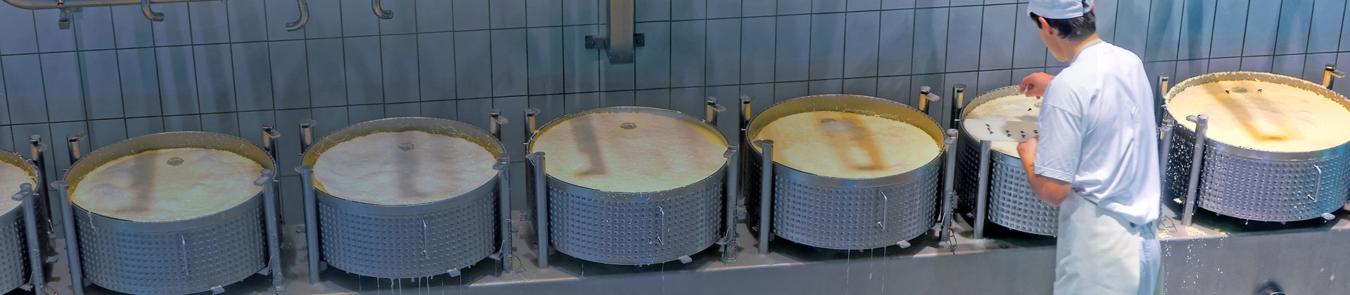 Large cooking vats filled with a liquid.