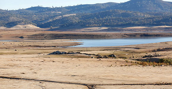 A photo of a dried up lake or river in an arid region of the world